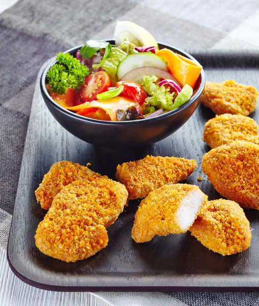 🐔 Chicken nuggets and salad.