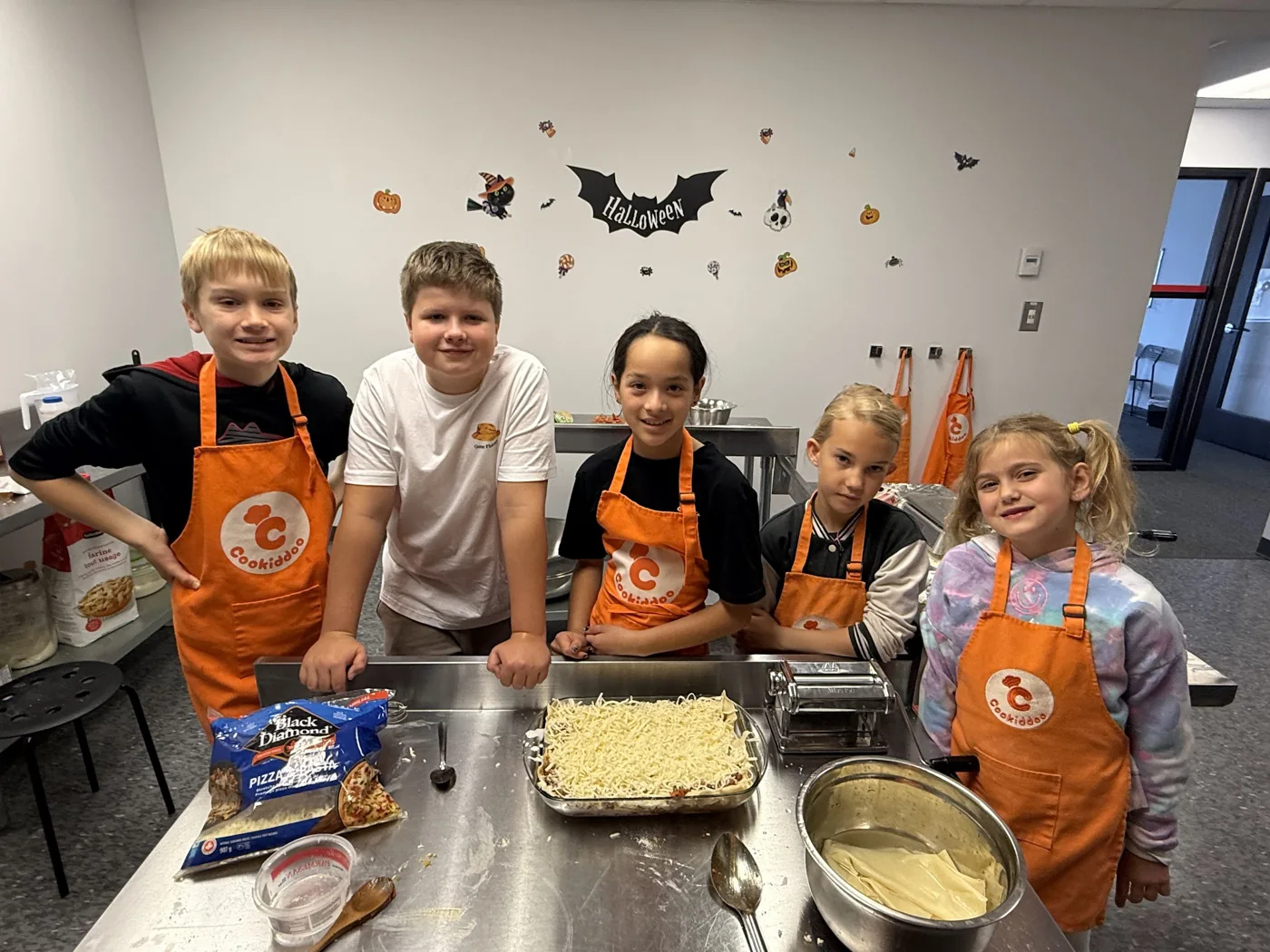 Kids at a Cookiddoo summer cooking camp preparing food together in Kanata, Ottawa