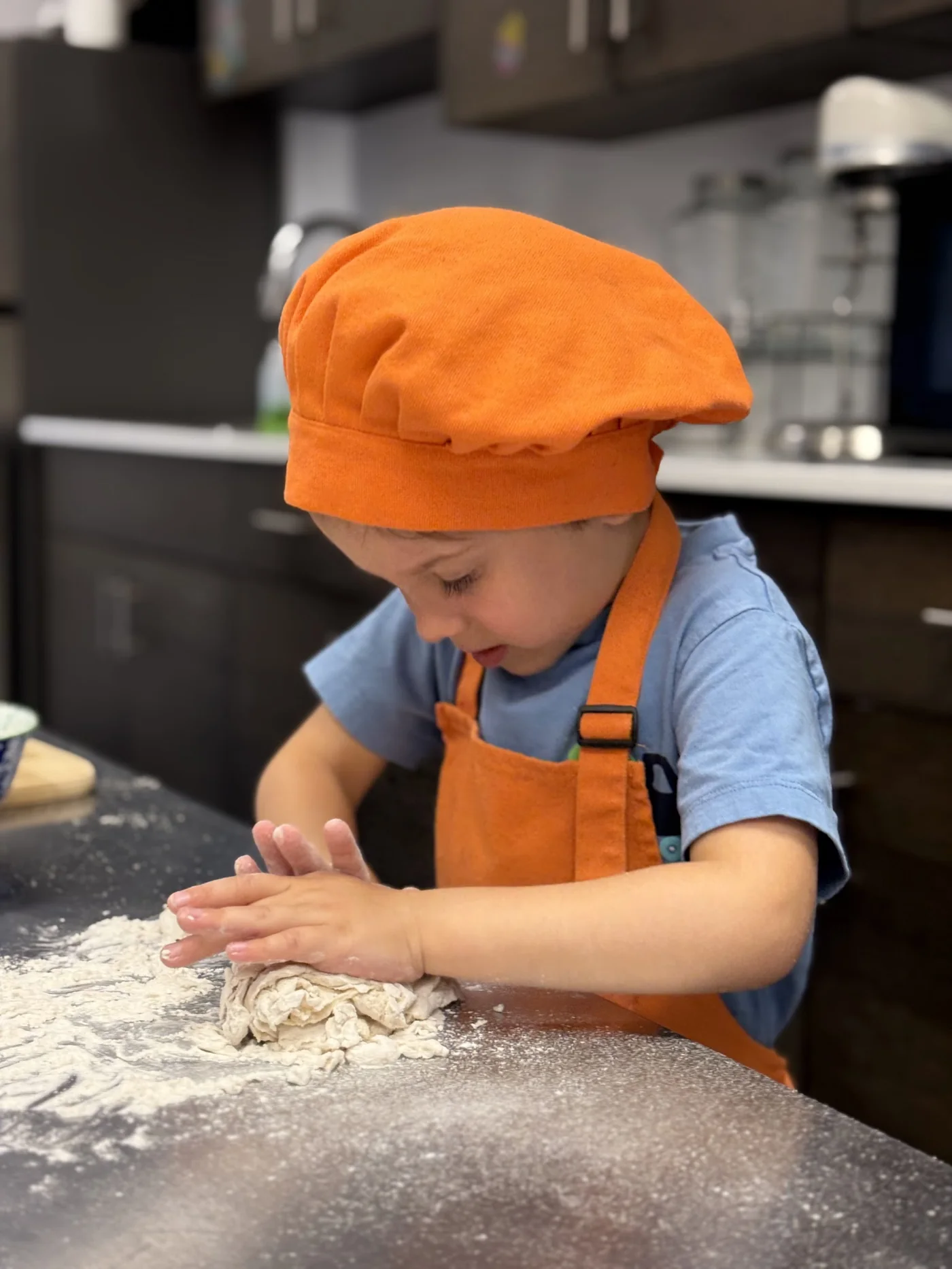 Young chef kneading dough during a Cookiddoo cooking session in Ottawa