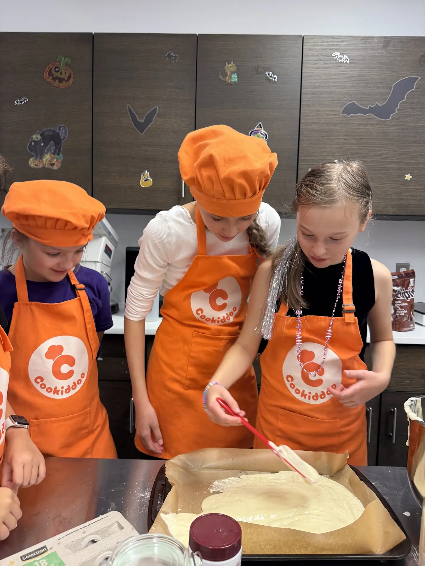 Children preparing dough in a Cookiddoo after-school cooking program in Ottawa